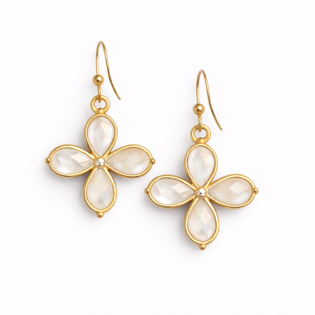Gold flower-shaped earrings with white stones on a white background