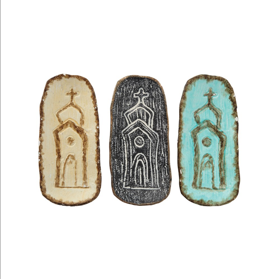 This unique Cast Iron Dish from Creative Co-op features a church building embossed in the center. Its distinct design is available in three different colors, and it has brown rims on all sides. The ideal size for serving hors d'oeuvres it can also be used as a decorative piece, and is 6"L x 2-3/4"W. Items are priced separately
