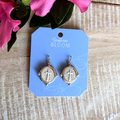 Gold cross earrings on a 'Southern Bloom' branded card with pink flowers in the background.